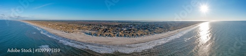 Drone panorama over Vejers beach in Denmark with sunshine and snow