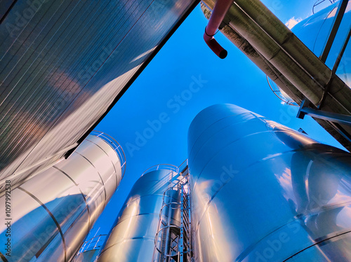 Giant metallic tanks at power plant, exterior view. Energy and engineering