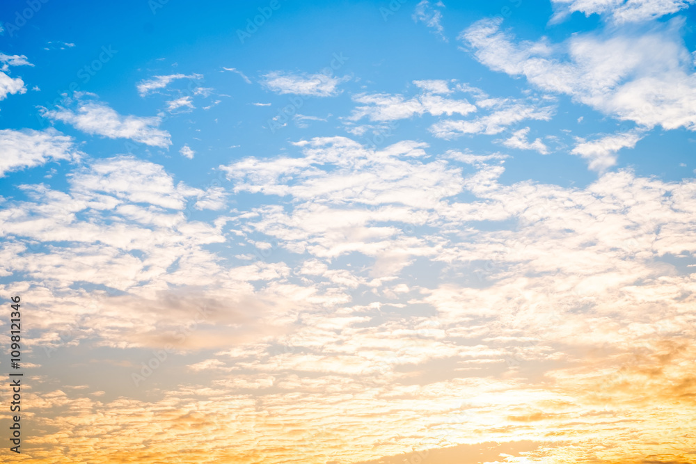 Obraz premium Beautiful , luxury soft gradient orange gold clouds and sunlight on the blue sky perfect for the background, take in everning,Twilight, Large size, high definition landscape photo