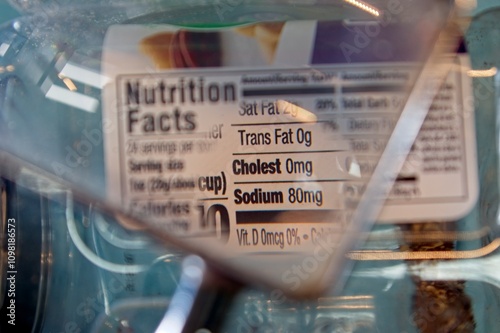 Magnifying glass focusing on cholesterol and sodium on a food label photo