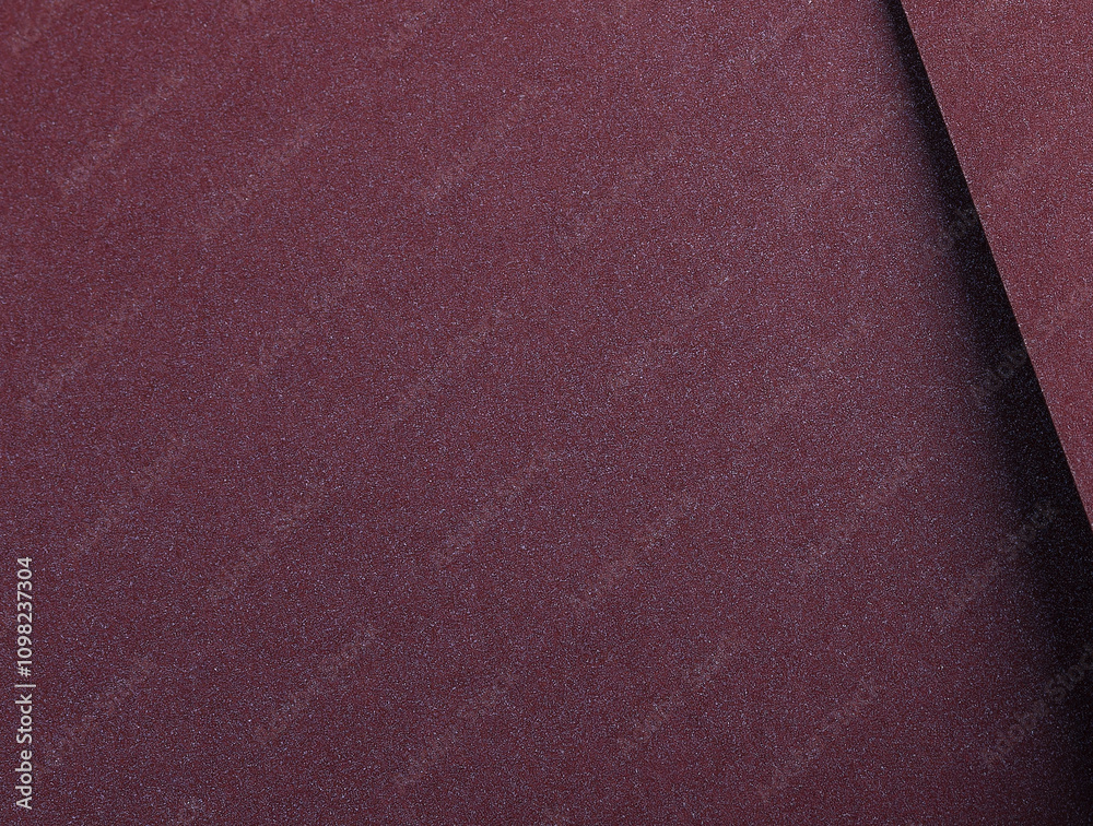 Fototapeta premium Burgundy metallic paper background with a smooth, shimmering surface and elegant gradient. Featuring soft folds and a glossy, reflective finish, it exudes a luxurious and refined