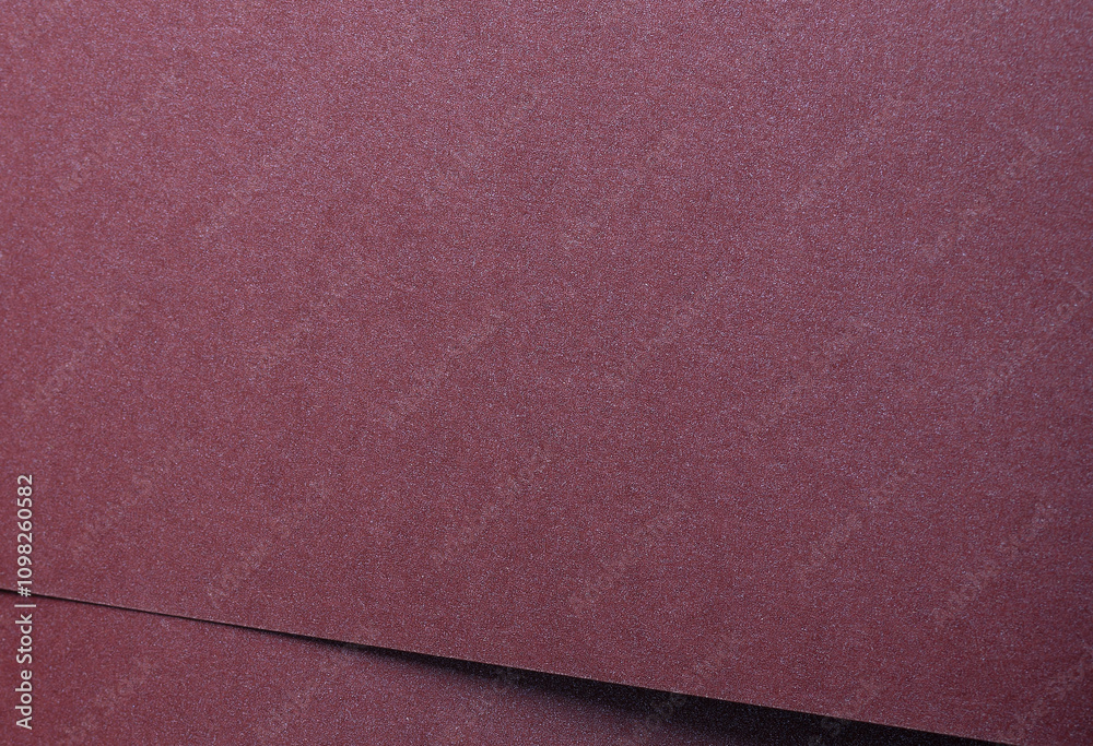 Fototapeta premium Metallic burgundy paper background with smooth, shimmering layers and subtle folds. Featuring deep, rich tones and a soft satin sheen, it combines luxury and modern elegance.