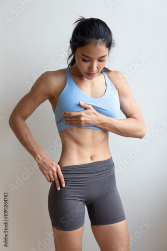 Six-packs abs, V line or V cut abdominal muscle, strong fit healthy happy Asian woman with strong muscle, lean body, showing abdominal muscle, fitness gym, sport woman, fit muscle building concept photo