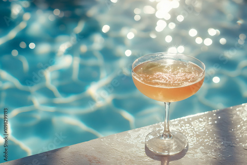 A colorful cocktail rests by a sparkling pool in the warm sun, inviting you to relax photo