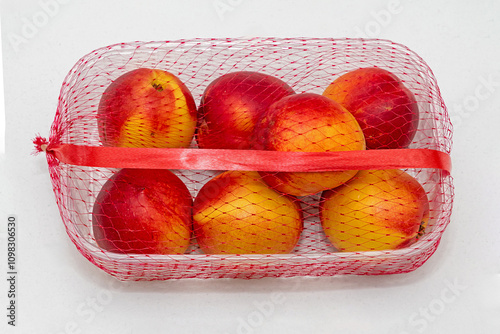 Nectarine peaches fruits inside plastic tray on table