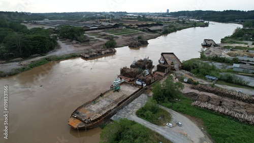 Bintulu, Malaysia - November 23, 2024: The Factories of Jepak Industrial Estate along Kemena River photo