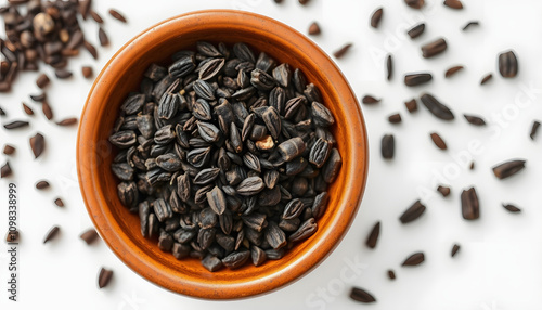 Kalonji (black cumin) in a brown ceramic bowl highlighted by white. Isolated close-up photo of food close up from above on white background isolated highlighted by white, png photo