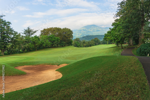 Panorama View of Golf Course with putting green in Taman Dayu Pandaan, Pasuruan, East Java, Indonesia. Golf course with a rich green turf beautiful scenery. photo