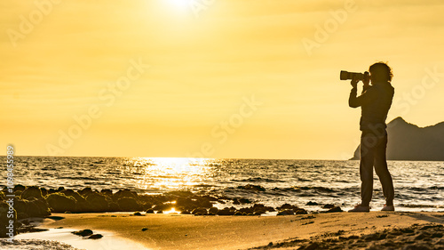 Woman with camera on Monsul beach, Spain