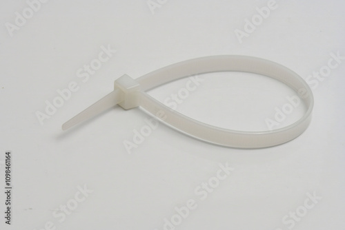 Nylon Cable Tie Isolated on White Background
Close-up of a black nylon cable tie (zip tie) isolated on a white background, representing fastening and organizing tools.
