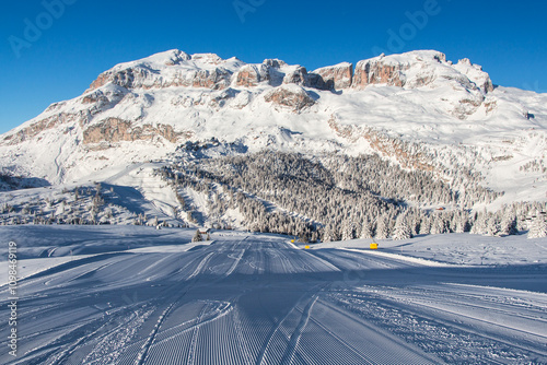 Fresh groomed ski slope with amazing winter landscape in the Alps, Dolomite mountain range, Alta Badia, Sella Ronda Italy