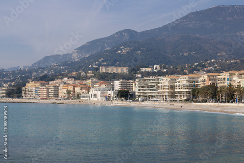 Plage de Fossan beach along the Mediterranean sea with the skyline in the city of Menton, in the French Riviera.