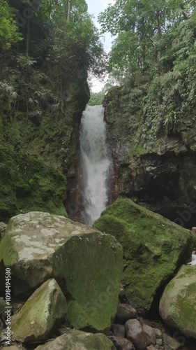 4K Video Vertical: Moss-Covered Rocks by a Towering Waterfall