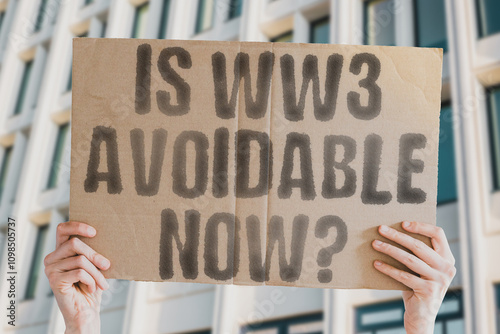 The phrase 'Is WW3 avoidable now?' on a banner in a person's hand. Human holds a cardboard with an inscription. Peace. Diplomacy. Conflict. Crisis. Security. Stability. Negotiation