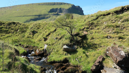 Benbulbin Mountain and Flowing Stream Amid Verdant Hills photo