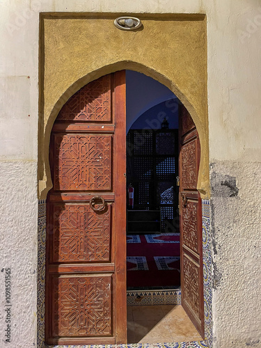 Wooden doors agains white-washed homes in Morocco photo