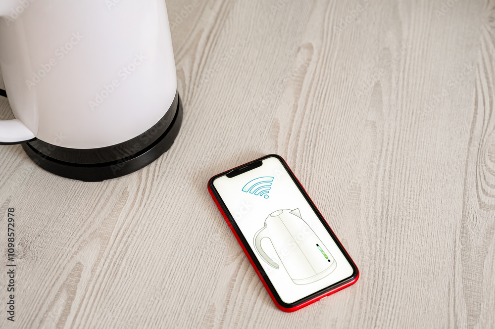 Smartphone controlling a smart kettle remotely using a mobile app with a Wi-Fi connection. Smart Home