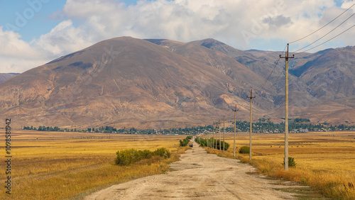 Truck on the gravel road. Lake Sevan area. Mountains in the background. Sevan, Armenia.