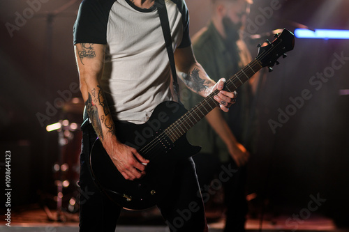 Guitarist playing electric guitar during live rock concert on stage photo