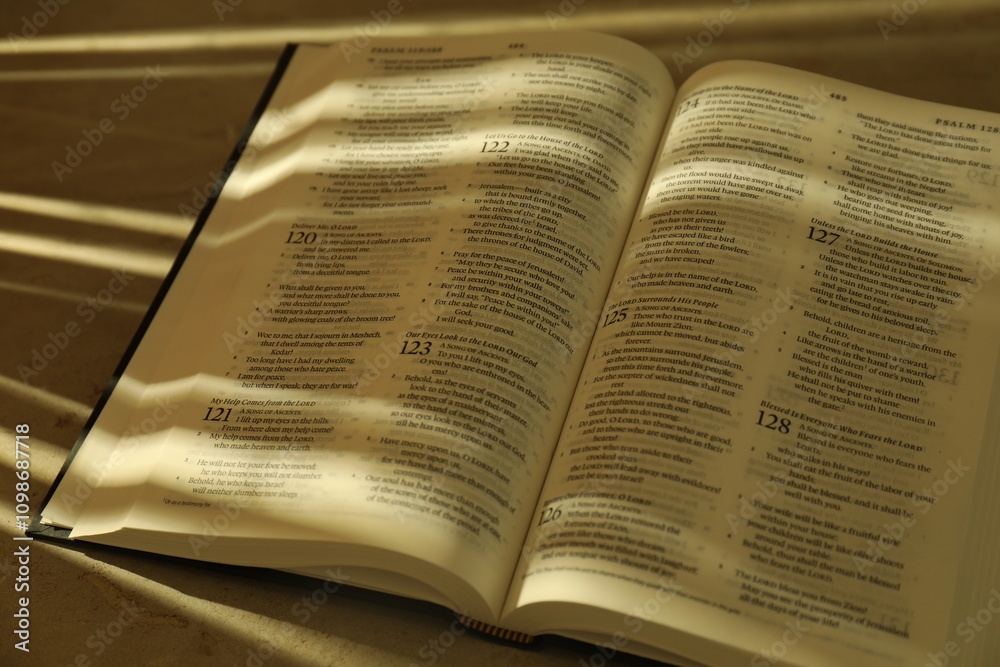Fototapeta premium Open Holy Bible in English language on table