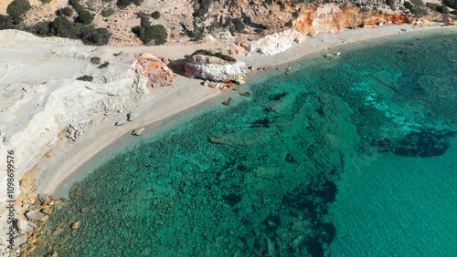 Aerial drone photo of secluded volcanic beach of Kastanas with colourful rock formations and crystal clear emerald sea, island of Milos, Cyclades, Greece photo