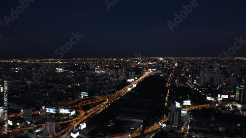 Wallpaper Mural BANGKOK, THAILAND - AUGUST 2024 : Aerial high angle rotating view of Bangkok city. View of buildings and streets around downtown Siam area at night. Torontodigital.ca