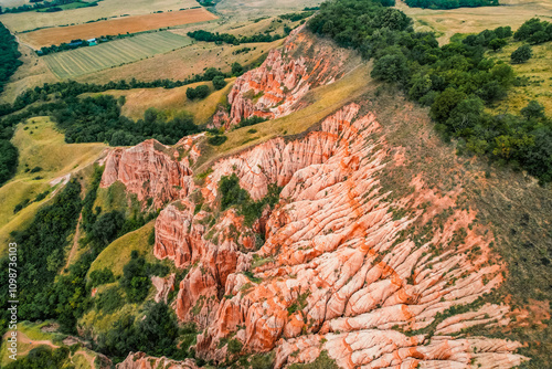 Red rocky slopes Rapa Rosie is a protected geological and floristic reservation area near Sebes alba in Romania photo