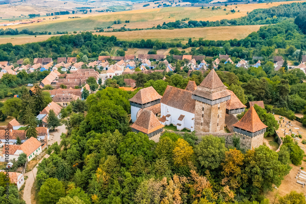 Obraz premium Viscri, Romania. Blue old painted traditional house from village, Transylvania. The Viscri fortified church