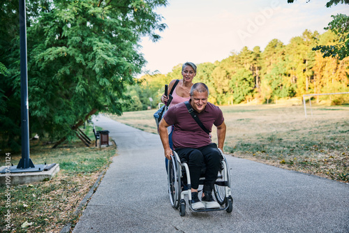 Man in Wheelchair Enjoying Nature on Park Pathway photo