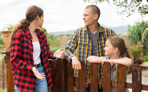 Farm neighbors talk at the border in village photo