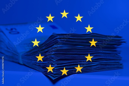 Картината върху платно Pile of fifty euros on the table with the European flag as background