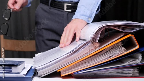 close-up of a lawyer leafing through the materials of a client's case