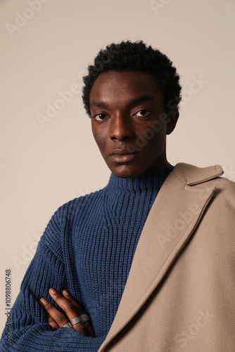 Vertical headshot of African American young man posing indoor. Vertical mock-up.