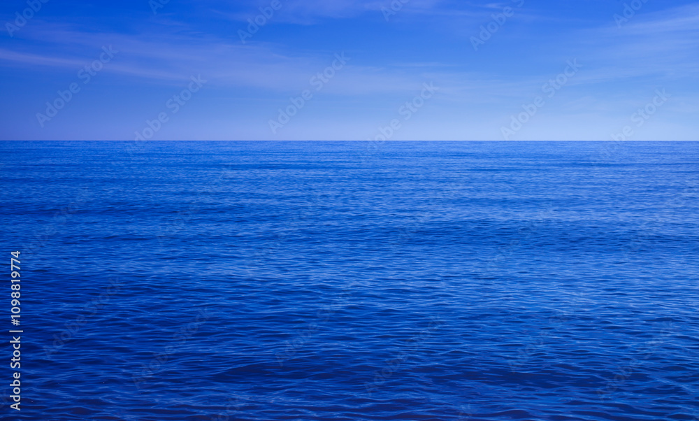 Fototapeta premium Blue ocean background, sea with evening sky, Ripple wave and calm sea with beautiful light