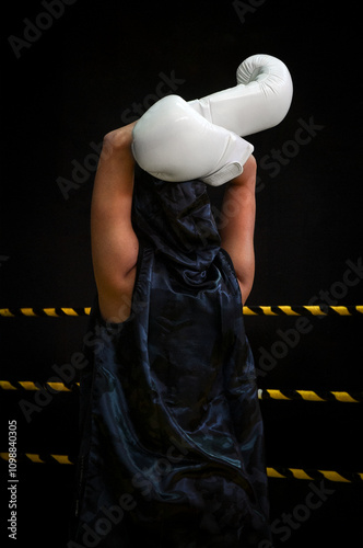 Boxer in Training with White Gloves in Dramatic Pose