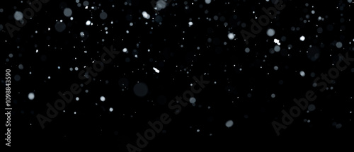 Real snowfall over black background. Abstract snowy white particles falling for winter weather overlay or cold snowfall background. Light snow storm.