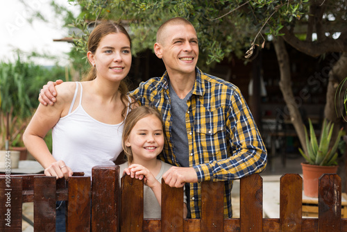 Portrait of friendly family in the courtyard of a country house. High quality photo photo