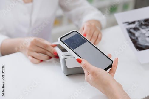 Digital payment at a clinic reception with a smartphone for a seamless and secure transaction photo