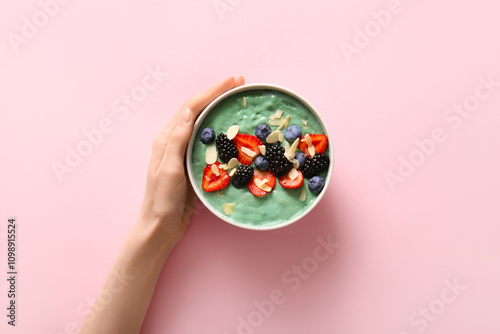 Female hand with bowl of ta...