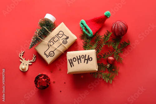 Beautiful composition with gift boxes and decorations on red background