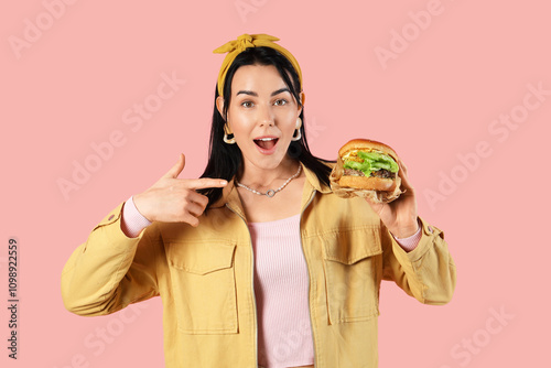 Surprised young woman point...