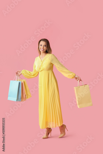 Happy young woman in yellow...