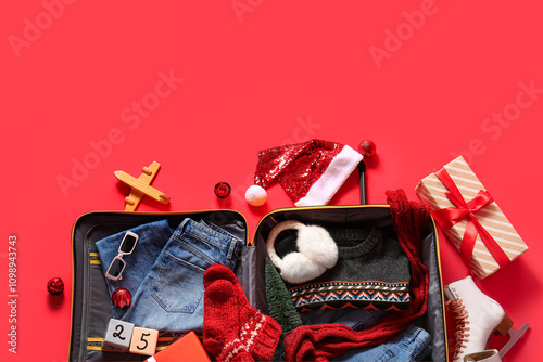 Open suitcase with winter c...