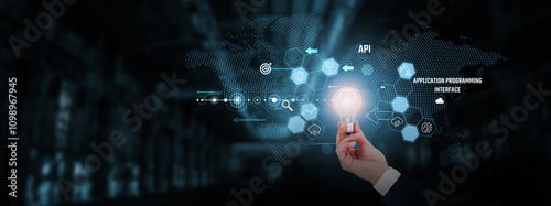 API (Application Programming Interface): Integration, connectivity, automation, data exchange, scalability, efficiency. Businessman hand holding creative light bulb with innovative technology.