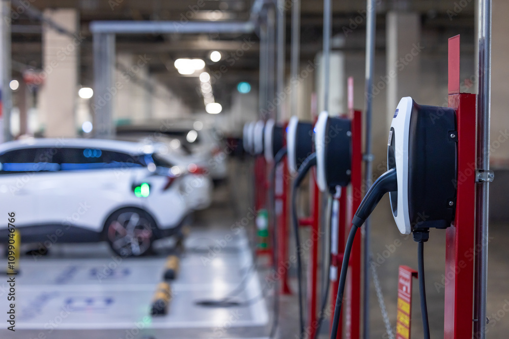 EV charger and electric car, Electric car charger station for charge ev battery, Plug for vehicle with electric engine, EV charger clean energy, Charging point at car parking lot department store.