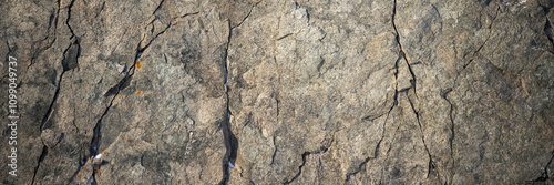 Rock texture. Cracks on the surface of the cliff. Natural stone background.