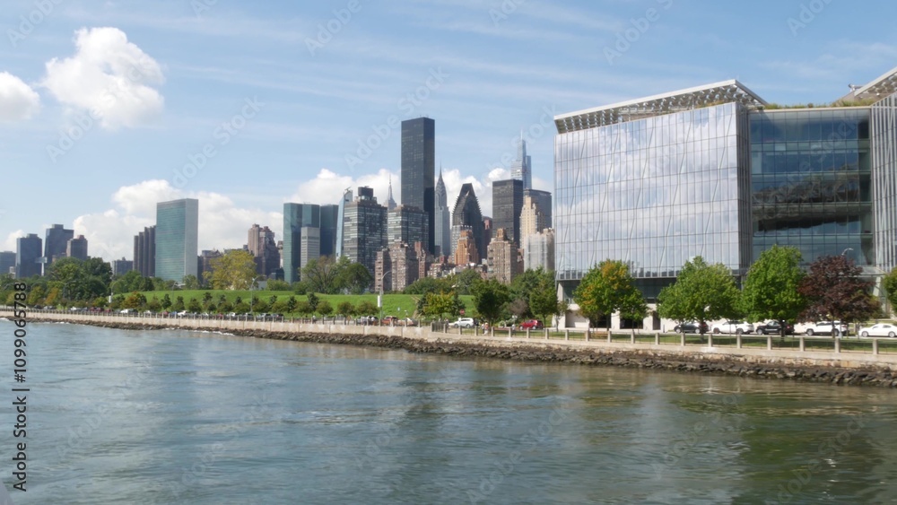 Fototapeta premium New York City skyline from ferry boat. Manhattan midtown near Queensboro bridge to Queens. Highrise architecture from ferryboat. East river waterfront riverfront architecture. Roosevelt Island, USA.