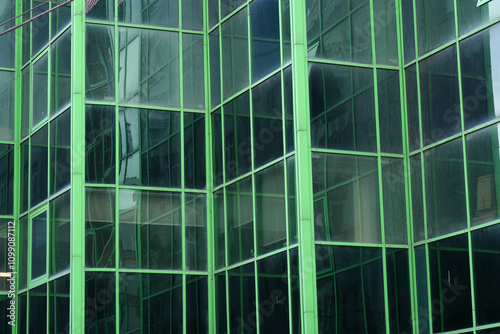 Bild auf Leinwand A Modern Green Glass Building Facade Featuring Striking and Intricate Geometric