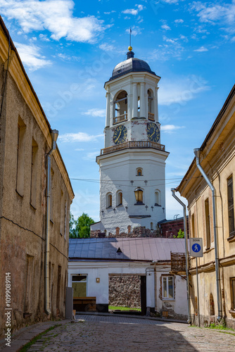 An old clock tower in the city landscape. Vyborg, Leningrad region. Russia photo