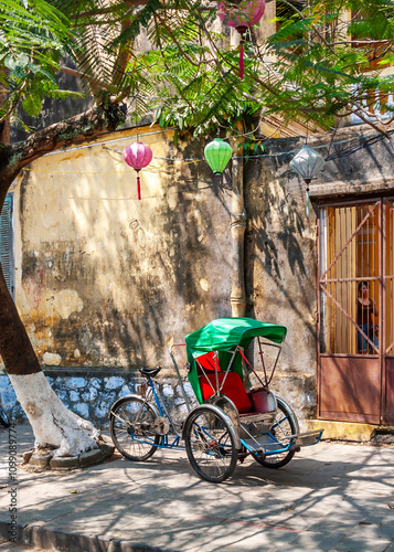 Traditional cyclo parked on the pavement, Hoi An, Vietnam photo